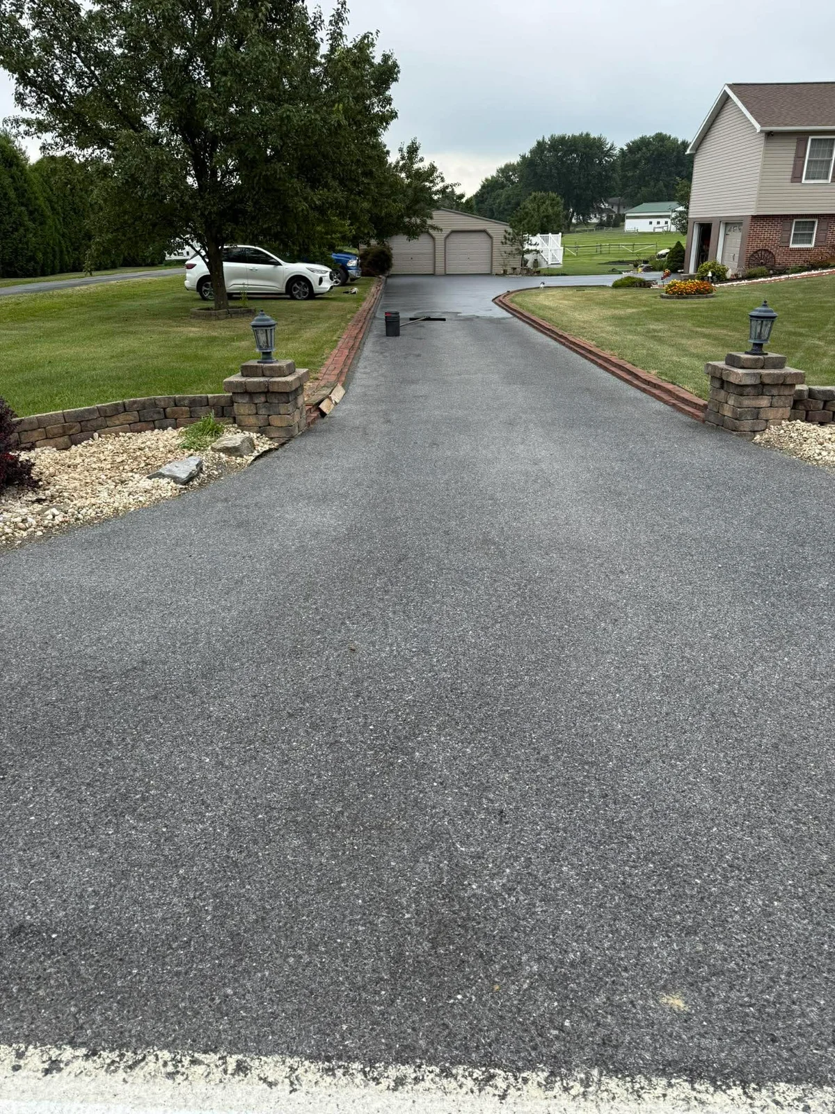 Cracked aged driveway before crack filling and sealcoating