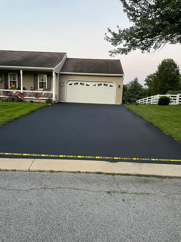 Sharp clean asphalt driveway after professional maintenance service