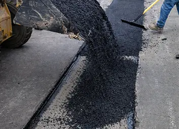 Asphalt patching repairing potholes and structural failures